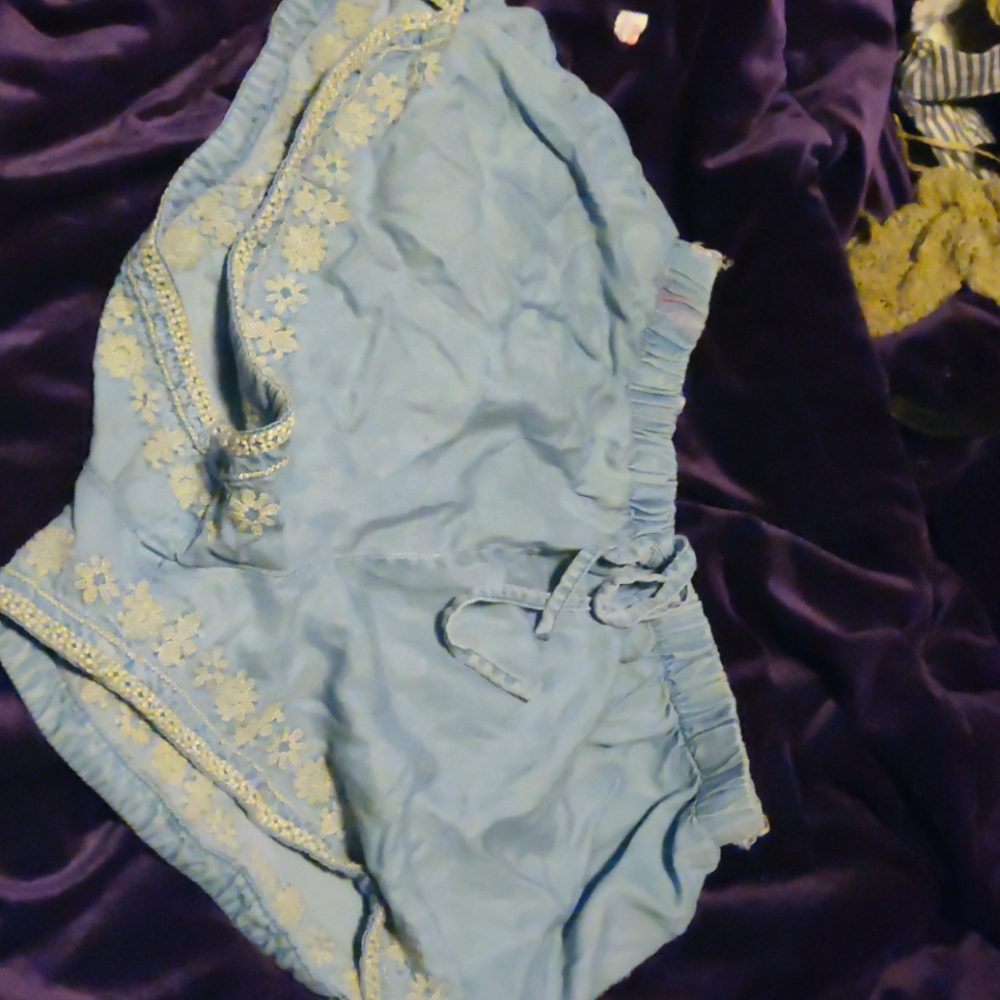 Francesca's shorts, has 3 small stains and a tear.